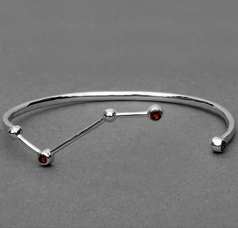 Constellation-inspired open bangle bracelet with gemstone accents in silver