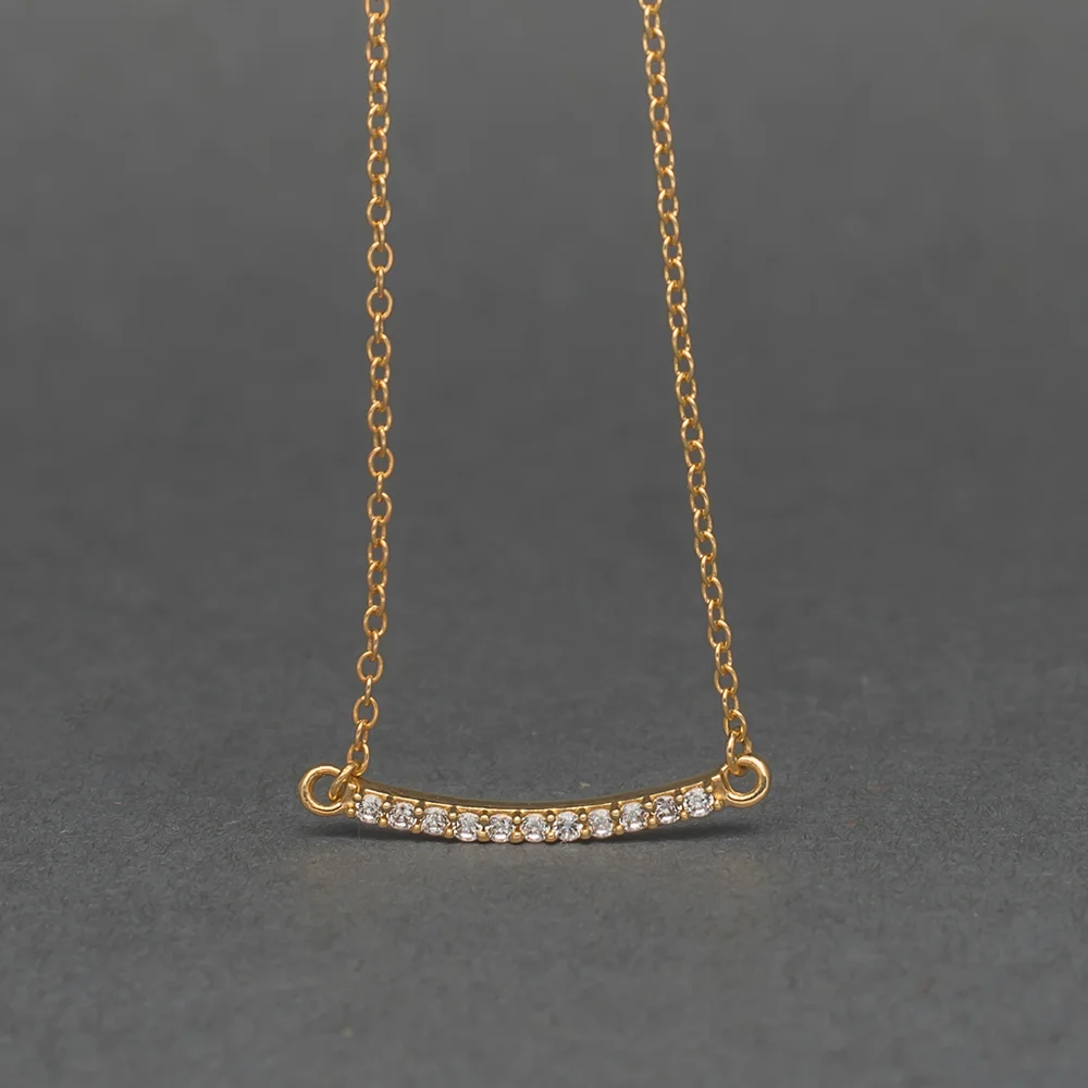 Gold pavé curved bar necklace with delicate stone detailing