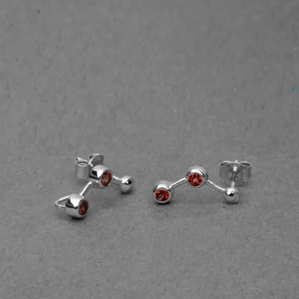Sterling silver red garnet crawler stud earrings with bezel-set gemstones and polished finish.