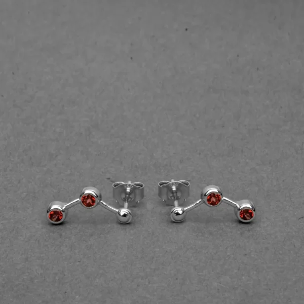 A pair of wide silver-toned huggie hoop earrings with an intricate openwork lattice design, featuring milgrain texture and pavé-set clear stones on a gray background. SEO Focus: Vintage-style silver filigree wide hoop earrings with pavé diamonds.