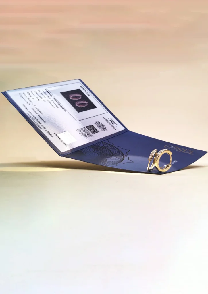 Elegant diamond and gold rings displayed with certification card by an Ethical Jewelry Supplier & Manufacturer